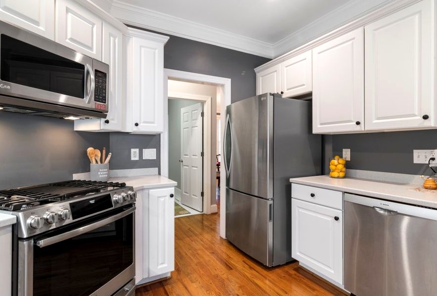 Contemporary kitchen with stainless steel appliances and white cabinets