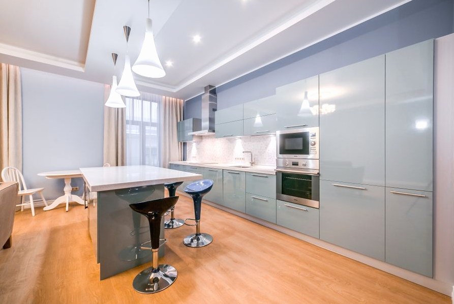 Spacious minimalist kitchen with sleek cabinets and modern lighting